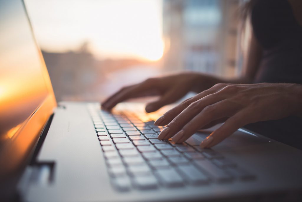 Person Typing on a Laptop Keyboard